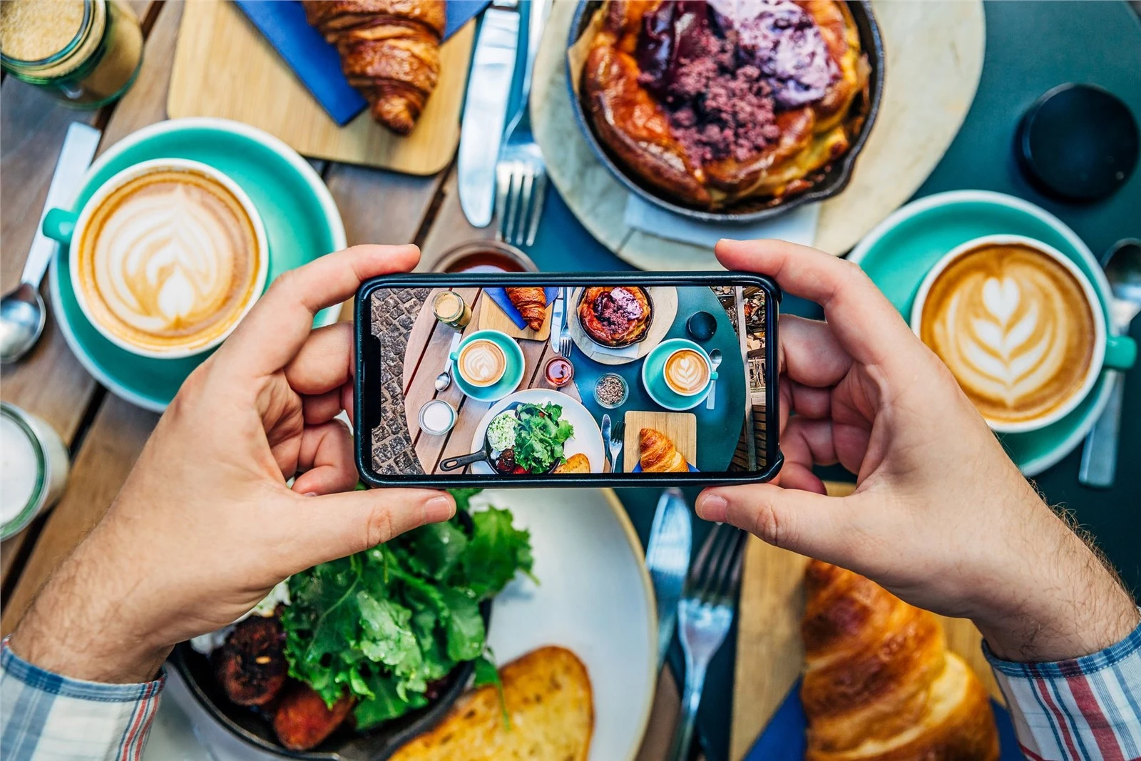 man-photographing-breakfast-in-a-cafe-with-royalty-free-image-1582212981